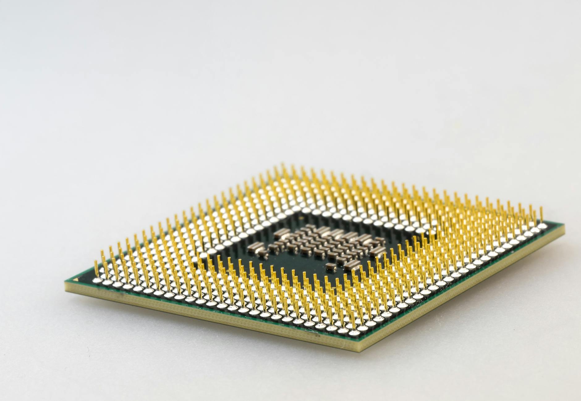 A detailed close-up of a CPU microchip showcasing its intricate gold pins and technology.