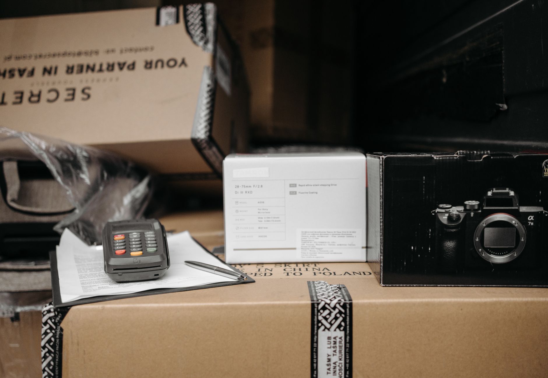 Assorted packages with camera equipment ready for shipment in an indoor setting.