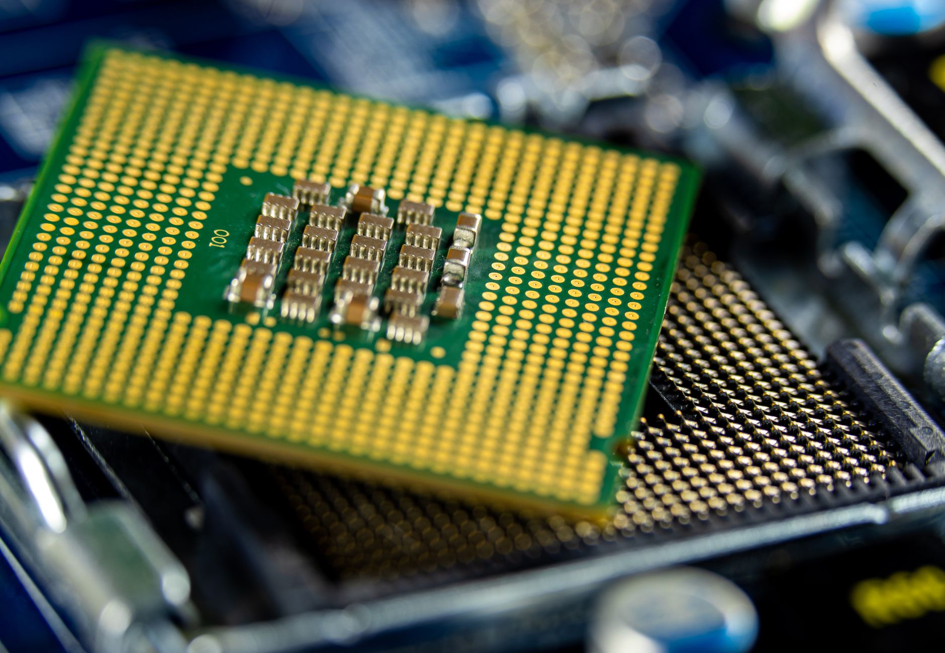 Detailed close-up of a microprocessor on a motherboard showcasing its intricate design.