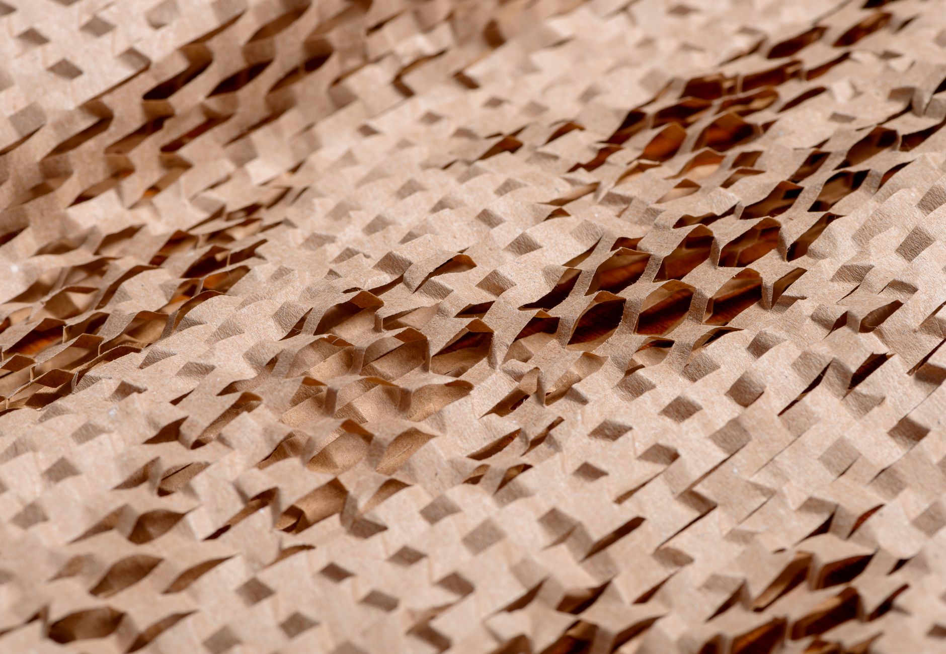 Detailed view of an intricate, textured brown paper pattern with cut-out layers.